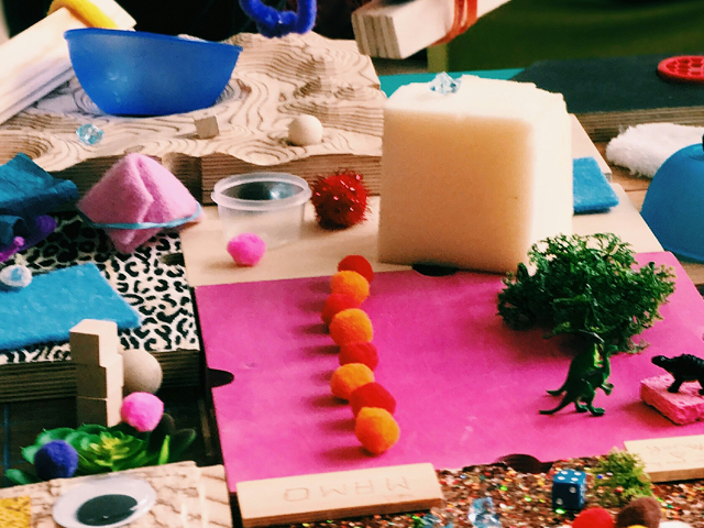 Paper, pom poms, and assorted craft and art supplies