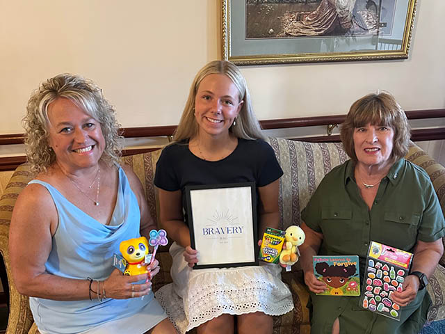 Pictured from left to right, sitting on a couch with bravery bags, are Carrie Penoyer, Rotary Interact Advisor, Lylah Lukowski, Sabine Ingerson, Oswego Rotary Club President