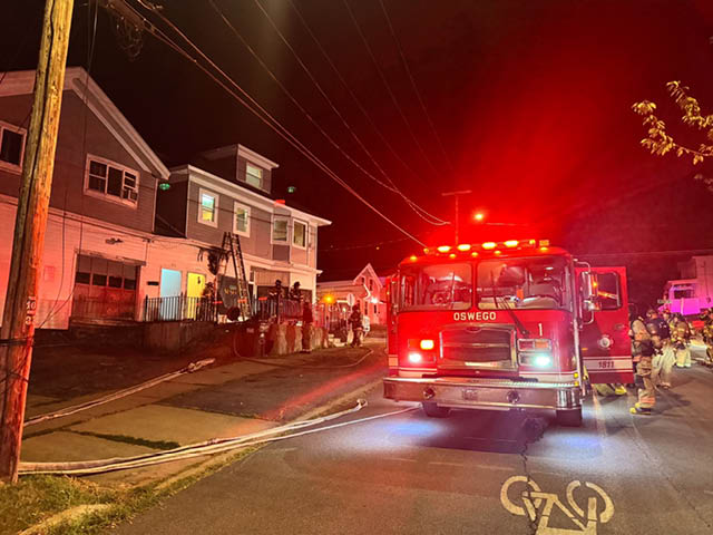 Fire truck parked in the street in front of the structure at 173 W. Seneca St.