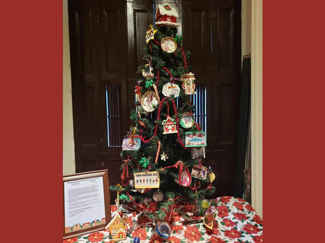A tabletop Christmas tree decorated by Oswego County Fair Housing for the Parade of Trees in Fulton