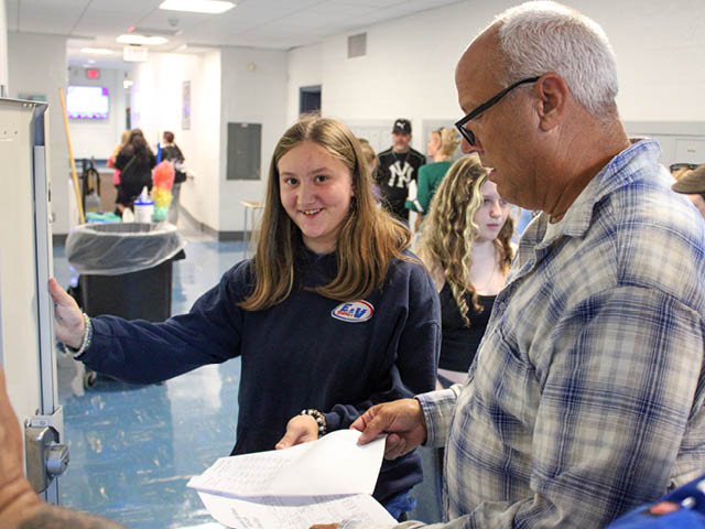 Hannibal High School Principal Stephen Dunn is pictured helping an incoming freshman successfully open her locker during Freshman Academy, an orientation day at HHS.