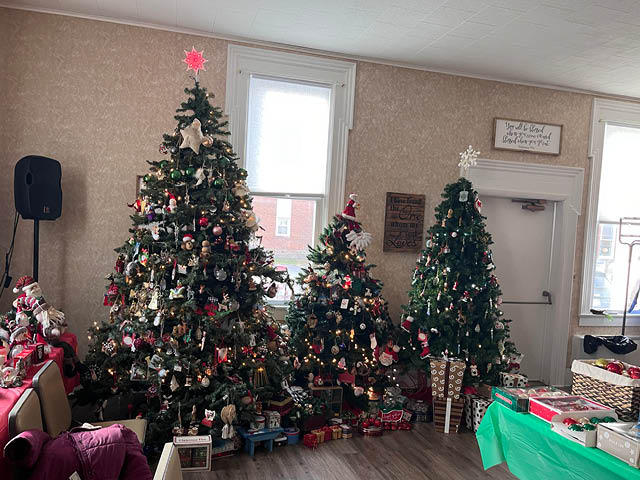 Three fully decorated Christmas trees in the Hannibal Community Church