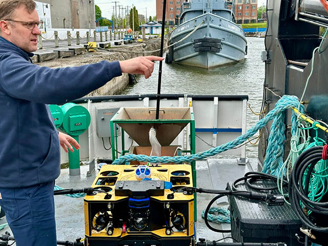 Jason Fahy pointing on the research vessel