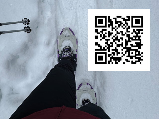 A photo of someone's feet wearing snowshoes in the snow. A QR code sits in the upper right-hand corner of the photo
