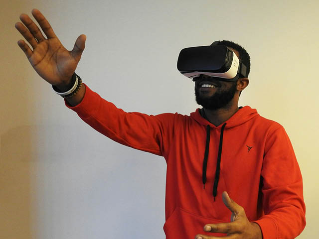 Stock photo of a man using VR goggles and gesturing