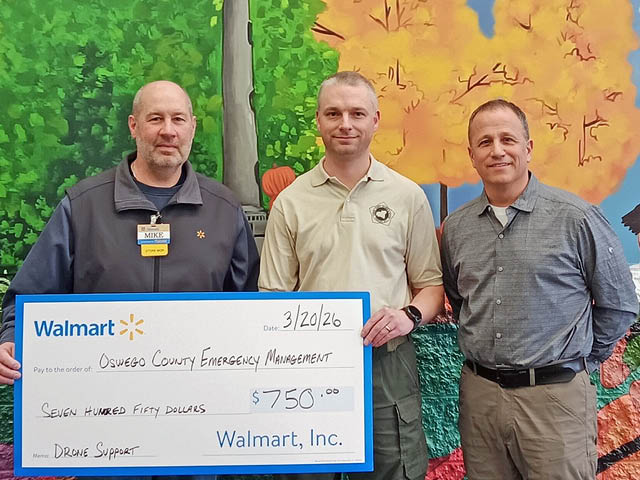 Photo of three men with a presentation check from Central Square Walmart
