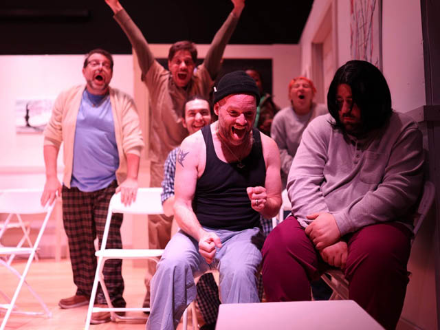 Actors on a stage during rehearsals for One Flew Over the Cuckoo's Nest