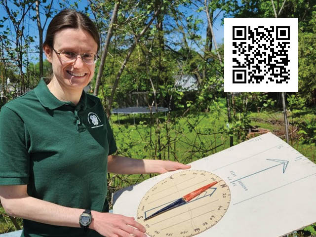 Photo of a woman standing in the woods with a hand-made compass; QR code in upper right
