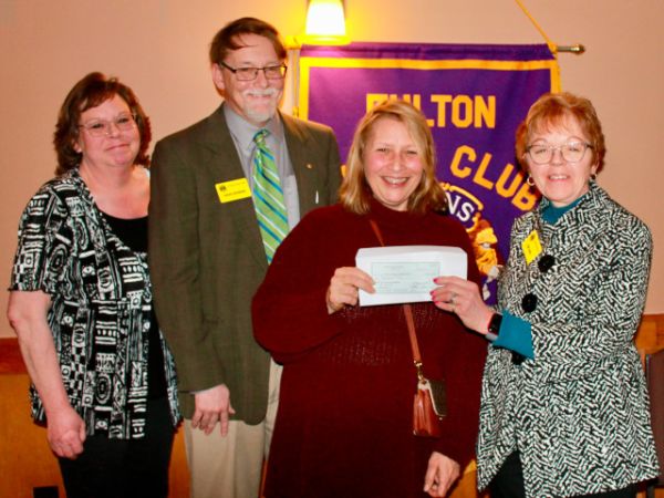 Daun Whittaker, third from left, former executive director, Victory Transformation (VT) of Oswego, was the featured speaker at the March 16 meeting of the Fulton Lions Club. Here she accepts a $1,000 donation from the club. Joining her were, from left, Michelle Stanard, Fulton Lions treasurer; Acting President Patrick Devendorf; and Lion Mary Curcio, VT’s interim executive director.
