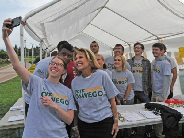 Politics in action -- SUNY Oswego political science faculty member Dr. Allison Rank (front) -- shown here with college President Deborah F. Stanley and student volunteers during a nonpartisan Vote Oswego &quot;blitz week&quot; event on campus prior to the 2016 presidential election -- has earned the national John Saltmarsh Award for Emerging Leaders in Civic Engagement from the American Democracy Project.