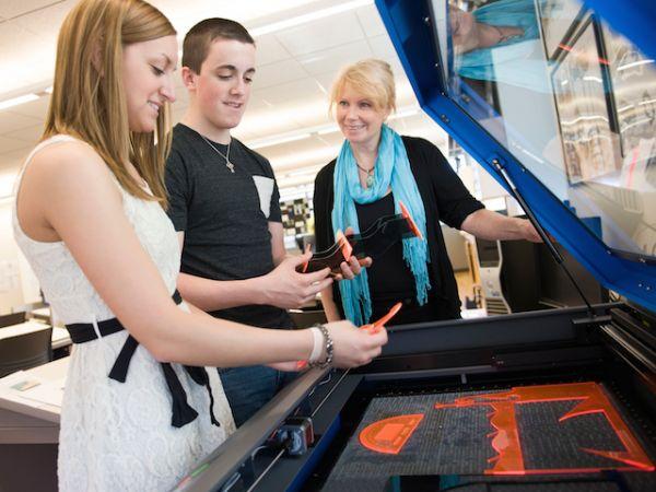 Technology professor Donna Matteson works with students in a new lab at SUNY Oswego.
