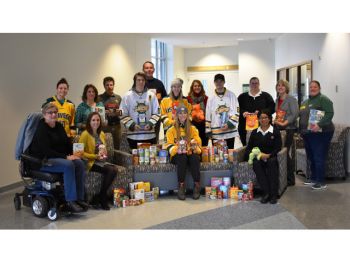 Pictured above are members from both hockey teams, representatives from the SUNY Oswego SEFA United Way Campaign Committee, United Way staff, and representatives from both the Human Concerns Center and Salvation Army of Oswego County, which were the agencies that shared this year’s collection.
