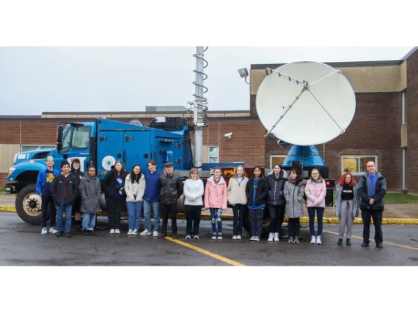 Jason Guild&#039;s OHS meteorology class gathers for a group photo in front of the Doppler on Wheels.
