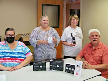 Golf tournament committee members showing a few of the prizes that will be awarded at the Sixth Annual Red Kettle Golf Classic on Saturday, June 18, at Battle Island State Park Golf Course. Shown L to R are Major Heather Odom, Carol Dexter, Wynnette Dohse, and golf classic chairman Tom Brown.